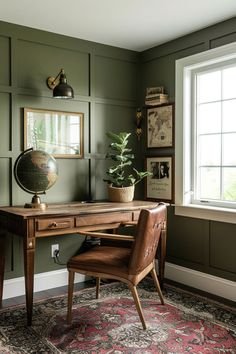 a desk with a chair and a globe on it in front of a large window