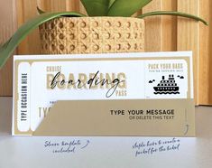 two boarding cards sitting on top of each other next to a potted green plant