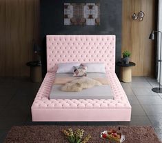 a bedroom with a pink bed frame and pillows on the headboard, along with other furniture