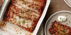 a square casserole dish with meat and cheese on the side next to two plates