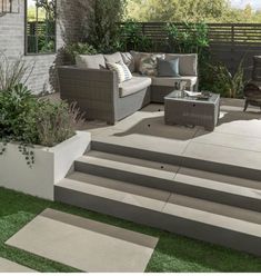 an outdoor living area with steps leading up to the patio