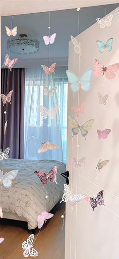 a bedroom with butterflies hanging from the ceiling