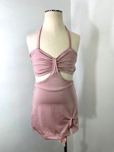 a female mannequin wearing a pink dress