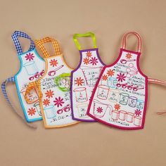 three aprons with different designs on them