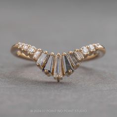 a gold ring with five baguets of diamonds