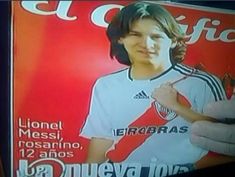 a man is holding up a poster for the soccer team