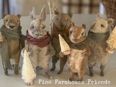 five stuffed animals standing next to each other in front of a window with the words fine farmhouse friends written on it