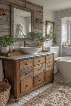 a bathroom with two sinks, a tub and a large mirror on the wall above it