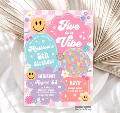 a pink and blue birthday card with smiley faces