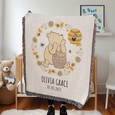 a baby's personalized blanket with a teddy bear and honeycombs