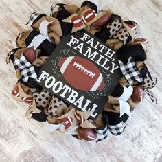 a football wreath with the words faith family on it