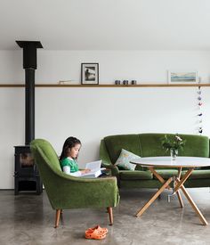 A late-1950s set of sofa and chairs inherited from Gaffney’s granny warm up the living room, as do the stove from Charnwood and the coffee table the couple bought from Habitat for their first flat.  Photo by Ben Anders. Rosa Sofa, Velvet Sofas, Picture Shelf, Pot Belly, Green Couch, Flat Photo, Old Sofa, Retro Sofa