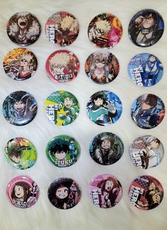 a bunch of anime buttons sitting on top of a white fur covered floor next to each other