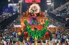 an elaborate float in the middle of a large crowd