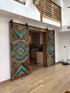 an open door in the middle of a room with wood flooring and white walls