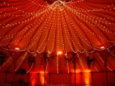 the inside of a large tent with lights on it