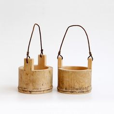 two wooden buckets sitting next to each other