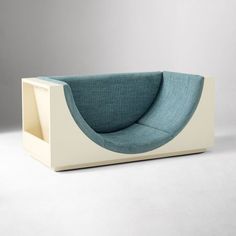 a blue and white couch sitting on top of a table