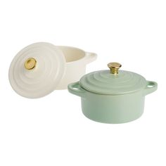 two green casserole dishes with gold handles and lids, one in white and the other in light green