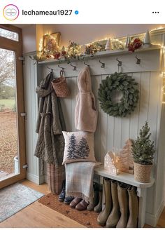 the entryway is decorated for christmas with wreaths, stockings and boots on display