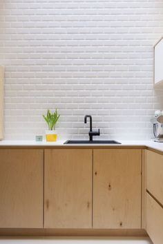 a kitchen with wooden cabinets and black faucet