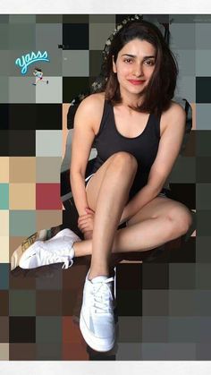 a woman sitting on top of a wooden bench next to a white tennis racquet