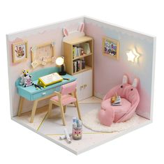 a doll house with a desk and chair in the corner next to a book shelf