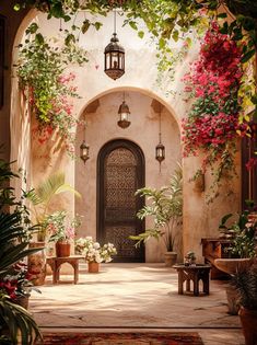 an entrance to a house with flowers and plants growing on the walls, along with potted plants