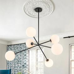 a chandelier hanging from the ceiling in a dining room