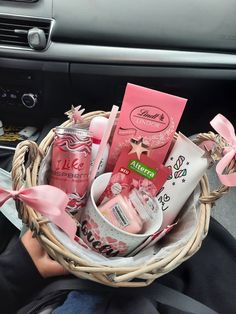 a basket filled with personal care items in the passenger seat of a car, next to a steering wheel