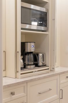 a microwave oven sitting inside of a cabinet