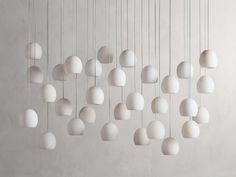 a bunch of white balls hanging from the ceiling