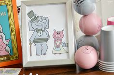 an elephant and pig are on the table next to some other items