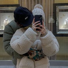 a woman taking a selfie with her cell phone in front of a store window