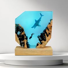 there is a glass sculpture with a shark in the water