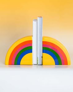 ceramic rainbow shaped bookends with books in the center Clay Bookends, Rainbow Bookends, Ceramic Book Ends, Ceramic Bookends, Ceramic Book, Ceramic Rainbow, Rainbow Order, Reading Rainbow, Book Ends