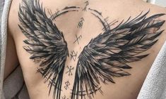 the back of a woman's chest with black wings on it