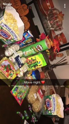 a table topped with lots of different types of snacks and candy bar wrappers on top of each other