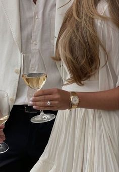 the man and woman are holding wine glasses