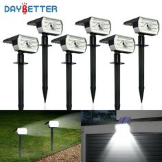 four solar powered garden lights on the side of a house and in front of a garage