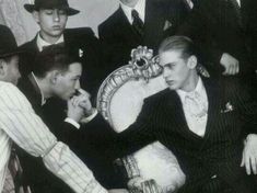 a group of men in suits and ties sitting next to each other