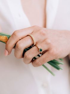 A round Emerald is delicately bezel set in a gold hammered band, along with a bezel set diamond and gold Dew Drop detail.This dainty everyday ring can be worn as a stackable set or on its own. Size: 7 Emerald Gemstone measures 5mm Diamond carat weight 0.03 14k yellow Gold Looking for a different ring size? Contact us at hello@meusshop.com Designed by Anzie Adjustable Emerald Ring, Dainty Emerald Ring With Bezel Setting, Stackable Emerald Ring With Round Band, Fine Jewelry Stackable Emerald Ring, Fine Jewelry Stackable Emerald Ring With Round Band, Elegant Adjustable Emerald Ring, Classic Stackable Rings With Bezel Setting, Open Ring Shape, Emerald Ring With Bezel Setting, Elegant Emerald Ring With Bezel Setting