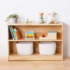 a wooden shelf with baskets and toys on it