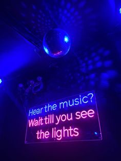 a neon sign that says hear the music? wait till you see the lights