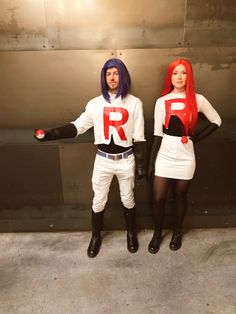 two people dressed in costume standing next to each other with their arms out and one holding the word rr