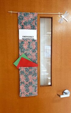 an emergency door hanger is decorated with candy canes and red, green, and blue paper