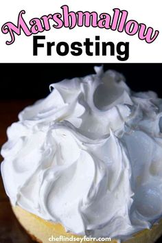 a close up of a frosted cake on a table with the words marshmallow frosting