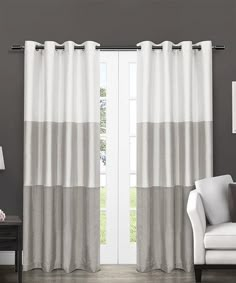 a living room with white and gray curtains