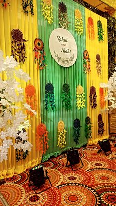 an elaborately decorated backdrop with flowers and ribbons on display in a room that is brightly lit