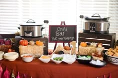 a table topped with lots of food next to a sign